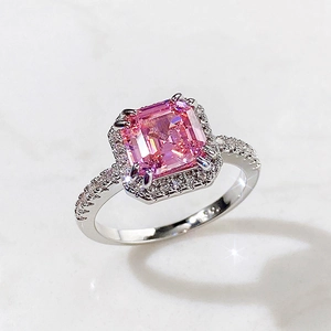 Detailed close-up of a square-cut pink gemstone ring with shimmering micro-pave diamonds