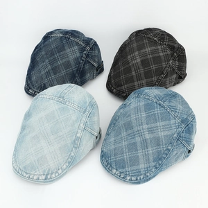 Top view of four vintage denim ivy caps in various plaid patterns and washed styles