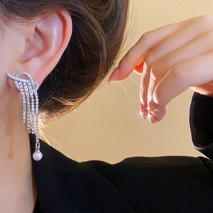 Elegant silver tassel earrings with sparkling zircons and pearls on model