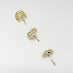 Detailed view of 3-piece minimalist gold alloy earring set with woven and smooth designs