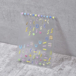 Detail shot of 5D macaron embossed nail stickers with textured lines and shapes