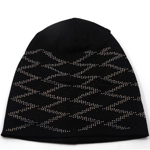 Detail of black knitted beanie with colorful rhinestone geometric wave patterns