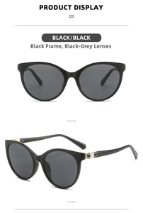 Detail view of black cat eye sunglasses featuring gold metal accents and geometric patterns