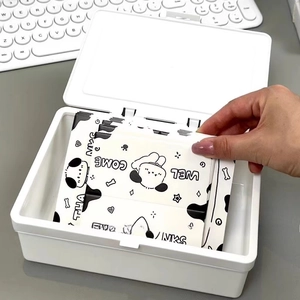 Close-up of white flip-top stationery organizer box featuring cartoon storage cards