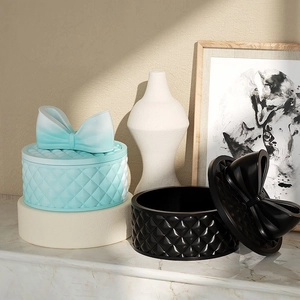 Quilted diamond pattern silicone storage box with bow lid in mint blue and black finish
