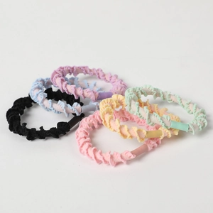 Elastic macaron-colored hair ties with pleated fabric texture in various pastel shades