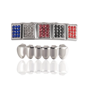 Hip hop silver dental grillz set with colorful rhinestones on white studio background