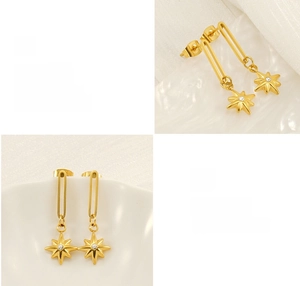 Detail of high-polish gold starburst pendant earrings with clear zircon center stone