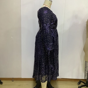 Detail of deep purple long sleeve dress featuring metallic gold star sequin patterns