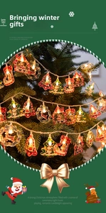 Detail showing festive LED string lights with bell, snowman, and reindeer shapes on a tree