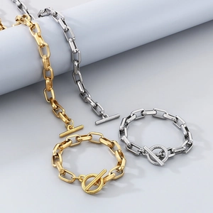 Detailed view of minimalist gold and silver geometric chain jewelry set with OT buckles