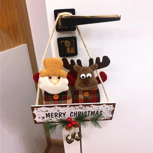 Christmas door hanger with Santa and reindeer plush, berries, and Merry Christmas sign
