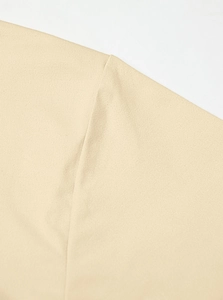 Detailed close-up of shoulder seam stitching on beige knit short sleeve T-shirt