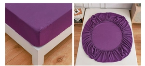 Detail view of deep purple fitted sheet with elastic band for full mattress coverage
