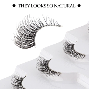 Close-up of six pairs of natural black half-lashes in a clear plastic packaging box