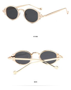 Detail of gold metal frame sunglasses with gothic hollow cross and filigree on temple