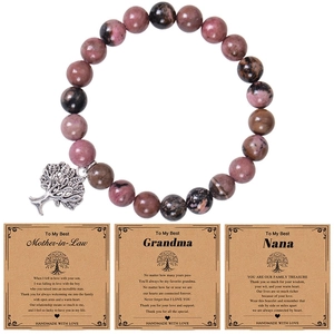 Detail of pink zebra stone bracelet with tree of life charm and three gift cards