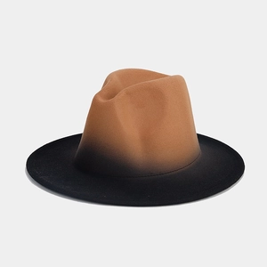 Detail view of the gradient ombre effect from brown to black on a felt fedora jazz hat
