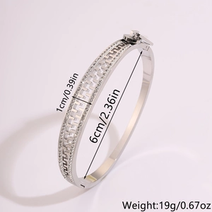 Detail view of silver stainless steel bracelet with H-link design and pavé crystals
