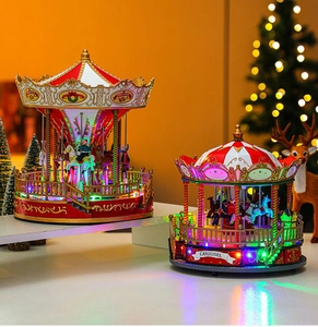 Detail of Christmas carousel music box with warm LED lights and festive red gold finish