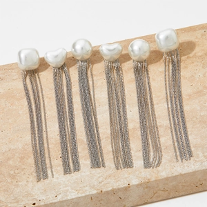 Detail showing assorted pearl heart and square shapes with silver metal tassels