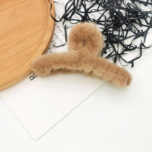 Brown plush claw clip for hair featuring soft faux fur texture and elegant shark clip design