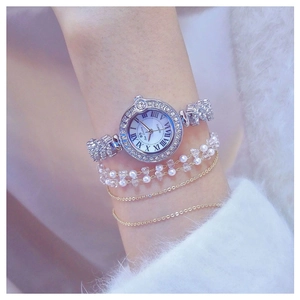 Detail shot of luxury quartz watch for women featuring rhinestones and elegant bracelets
