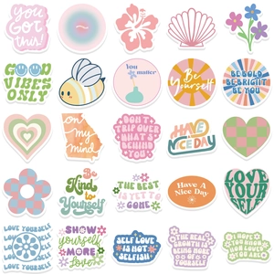 Flat lay of pink Danish aesthetic stickers with motivational quotes on a white background