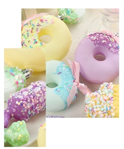 Close-up of pastel macaron donut and ice cream ornaments with glitter and beads