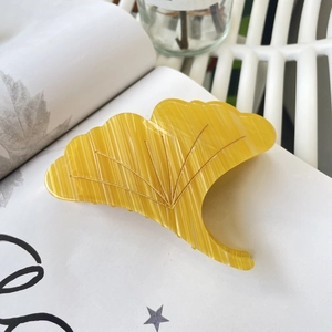 Elegant yellow ginkgo leaf hair claw clip with gold veining and acetate texture finish