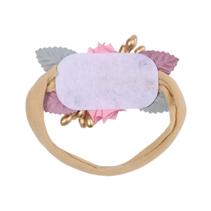 Detail showing soft nylon baby headband with colorful fabric leaves and felt backing