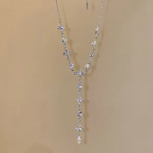 Elegant silver cross necklace with crystal teardrop pendant and sparkling Y-shaped chain