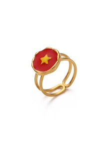 Detailed top view of gold-plated adjustable ring with red enamel and yellow star pattern