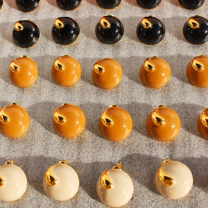 Handmade enamel round stud earrings in brown, yellow, and white with gold accents