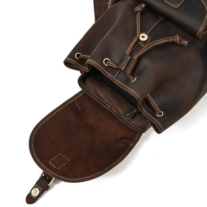 Detail of crazy horse leather backpack showing drawstring closure and metal buckle hardware