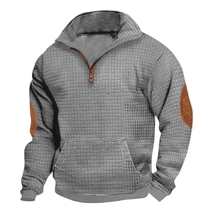 Close-up of grey waffle fabric texture and brown elbow patch on half-zip sweatshirt