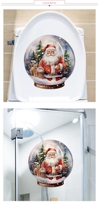 Detailed view of Christmas crystal ball stickers with Santa Claus on a bathroom toilet lid