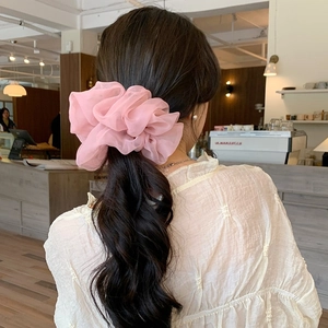 Elegant pink chiffon oversized hair scrunchie shown on model in natural lighting