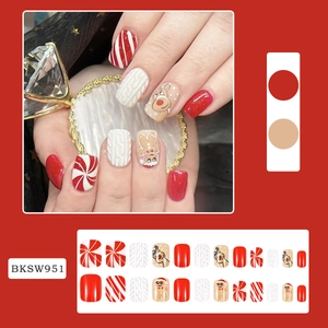Detailed Christmas nail press-on kit featuring gingerbread man and reindeer patterns