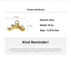 Pince à cheveux en métal doré avec dimensions 11,8x5,7 cm et poids de 40,7 g