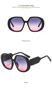 Detail of oversized black frame sunglasses with purple-to-pink gradient lenses
