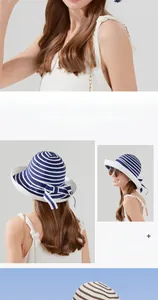 Detail view of summer straw sun hat with blue and white stripes and side bow accent