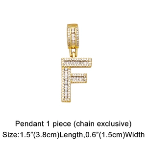 Macro detail of gold-tone letter F pendant with pave-set cubic zirconia in hip hop style