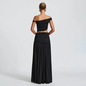 Women's black two-piece set featuring asymmetrical tube top and long slit skirt back view