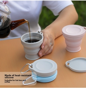 Collapsible silicone travel cups in grey, pink and blue with metal carabiner clips