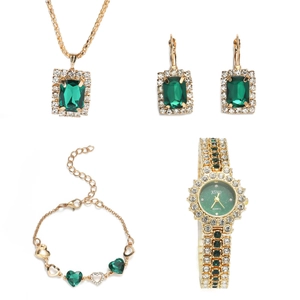 Women's gold watch and jewelry set with green gemstones and rhinestones in gift box
