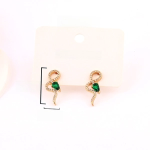 Elegant gold snake earrings with sparkling green diamonds on jewelry display card