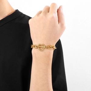Polished gold stainless steel O-chain bracelet with textured heart clasp on wrist