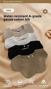 Close-up of four-layer soft cotton gauze baby bibs with adjustable snap buttons