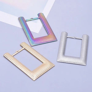 Three textured U-shape stainless steel necklace pendants in rainbow, gold, and silver